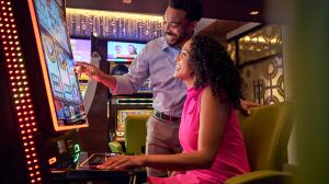 A couple playing at a slot machine